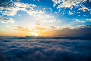 sun is rising on the summit in the morning and the mist.