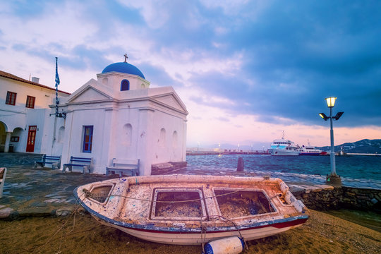 Abandoned boat near church in Mykonos, Greece