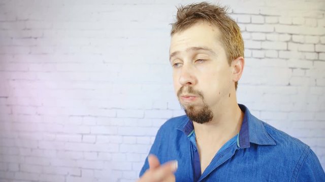 Funny person vomit after hear or see bullshit 4K. Portrait shot of a man in focus looking into the camera and starts to vomit and go unconscious dropping down.