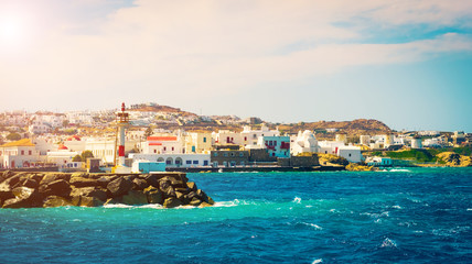 Beautiful view to Mykonos windmills and lighthouse from seaside