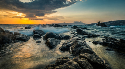 Beautiful seascape with rocks and waves at sunset