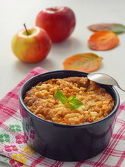 Close up of homemade crumble coffee cake. Portion of apple pie decorated with autumn leaves and...