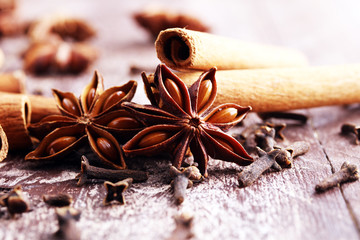 cinnamon, staranise and cloves. winter spices on wooden background.