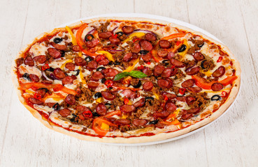Pizza with sausages and minced meat