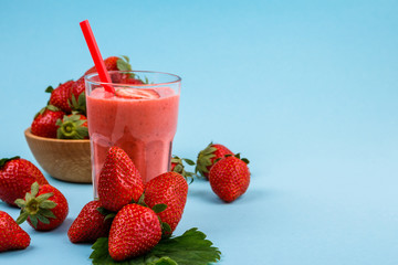 fresh strawberrysmoothie or milkshake on a delicately blue background