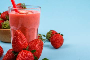 fresh strawberrysmoothie or milkshake on a delicately blue background