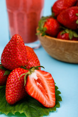 fresh strawberrysmoothie or milkshake on a delicately blue background