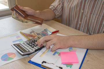 Fototapeta na wymiar Money and a calculator on the table. The concept of financial planning, savings