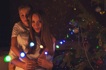 New year, christmas and family concept - happy mother and her son meeting New Year