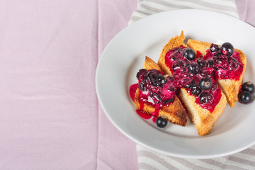 Delicious toasts bread with homemade currant jam with fork and knife