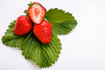 Juicy fresh strawberry on a white acrylic background