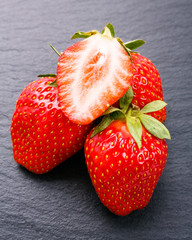 juicy fresh strawberry on a dark stone background