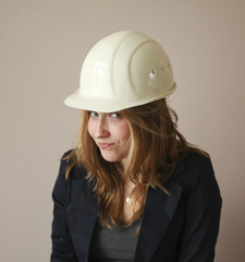 Pretty girl with construction helmet