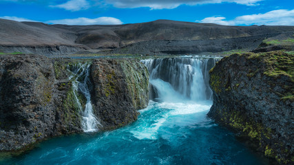 Panamanic view of waterfall in the highlands, Iceland in summer.