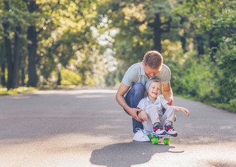 Father and son skating in summer