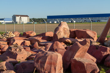 Red basalt cobblestones for landscape design on the market-stock stones. Red stones in the store of goods for landscape design. Design areas with rocks, stones and cobblestones.