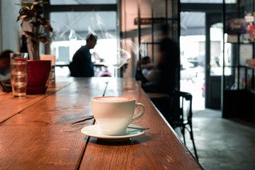 coffee cup on wood table in cafe