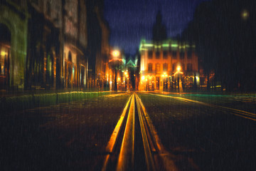 Old European illuminated city at rainy night