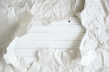 Obraz premium Texture white abstract background, crumpled white paper torn and white wooden board. Flat lay, top view, copy space 
