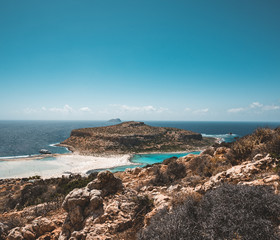 View of the beautiful beach in Balos Lagoon, and Gramvousa island on Crete, Greece. Sunny day, blue Sky with clouds.