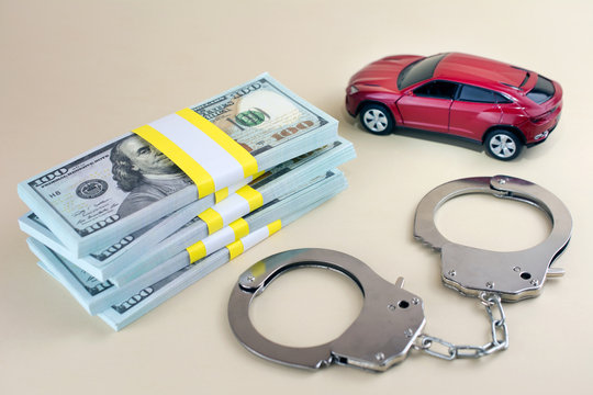  Red car  money handcuffs. shopping for vehicles fraud car sale,  breaking the law  concept.