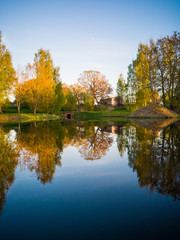 Fototapeta na wymiar Tree Reflection in the Lake on a Sunny Spring Day - Autumn Colours