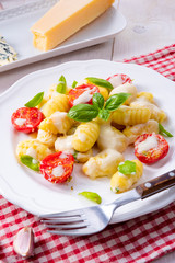 delicious gnocchi with gorgonzola cream sauce and cherry tomatoes