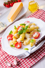 delicious gnocchi with gorgonzola cream sauce and cherry tomatoes