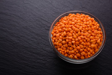 raw lentils on a dark stone background