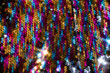 sequins colorful on the fabric. Texture scales of round sequins 