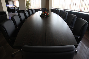 Empty corporate conference room with black furniture elements