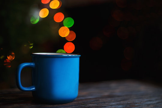 a cup on the wooden background . Christmas bokeh