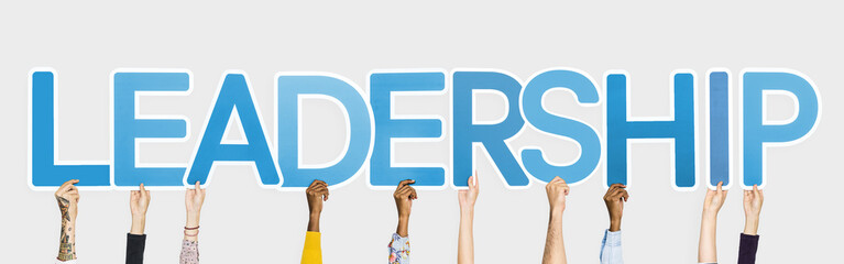Hands holding up blue letters forming the word leadership