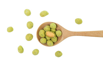 top view of wasabi crispy peanut snack balls in a wooden spoon isolated on white background.