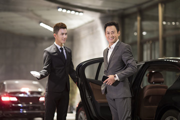 Chauffeur opening car door for passenger