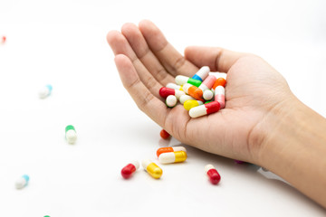 Colorful capsules tablets hold on hand. Image use for health care concept