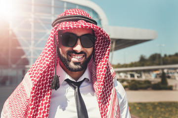 Portrait of arab man wears sunglasses and keffiyeh at the airport