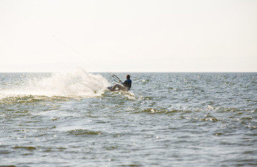Fototapeta premium Kite surfing by the sea in sunny weather