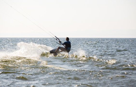 Kite surfing by the sea in sunny weather