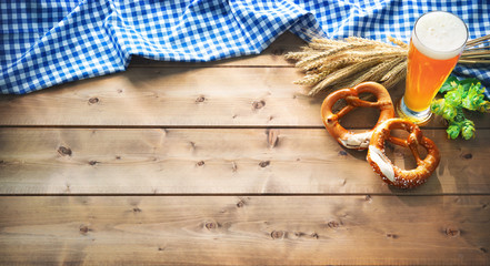 Oktoberfest background with Bavarian flag, beer glass and pretzel