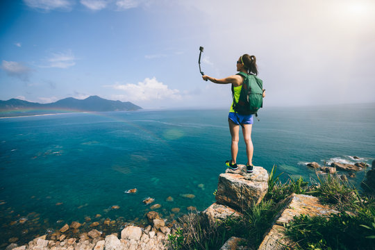 Woman Hiking In Seaside Taking A Selfie