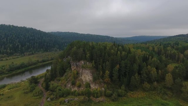 Flying over the beautiful autumn mountain River. Ural, Russia.