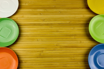 Color plates on wooden table background