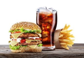 Hamburgers, French fries and cola on the table.