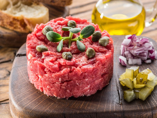 Steak tartare served with capers, pickled cucumbers and chopped onion.