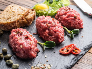 Steak tartare served with capers, pickled cucumbers and chopped onion.