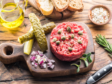 Steak tartare served with capers, pickled cucumbers and chopped onion.