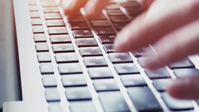 Typing on computer keyboard, closeup of fingers pressing keys, business communication office, information technology