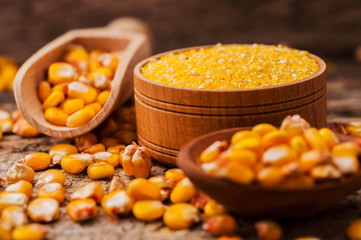 a bowl of corn is on a wooden table