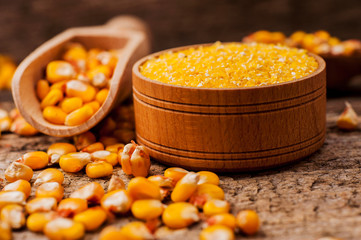 a bowl of corn is on a wooden table